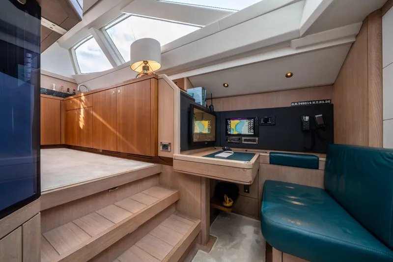 Karibu Yacht Photos Pics Luxurious interior of 2013 Oyster 885 yacht with navigation station and seating area.