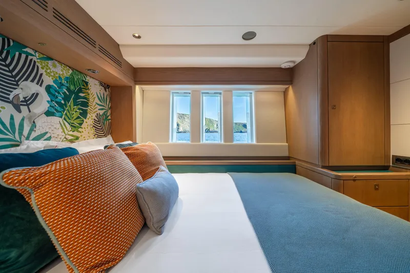 Karibu Yacht Photos Pics Luxurious bedroom interior of 2013 Oyster 885 yacht with vibrant decor and ocean view.