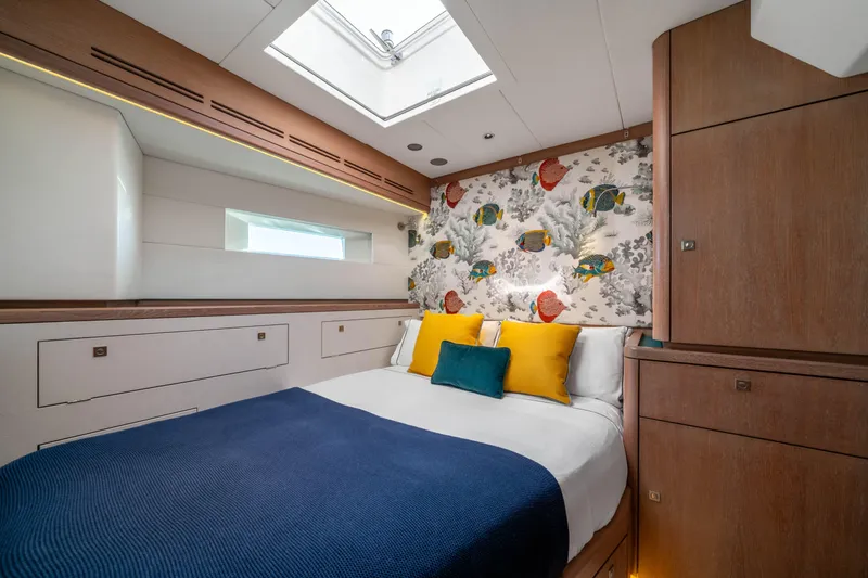 Karibu Yacht Photos Pics Luxurious bedroom interior on 2013 Oyster 885 yacht with vibrant fish-themed decor.