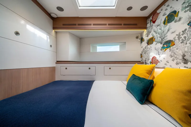 Karibu Yacht Photos Pics Luxurious cabin interior of 2013 Oyster 885 yacht with vibrant pillows and marine-themed wallpaper.