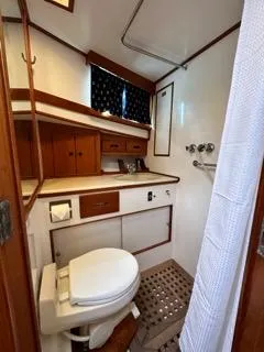 Its About Time Yacht Photos Pics 1996 Grand Banks Classic yacht bathroom with wooden cabinetry and nautical decor.
