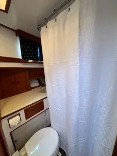 Its About Time Yacht Photos Pics Bathroom interior of a 1996 Grand Banks Classic boat with shower and toilet.