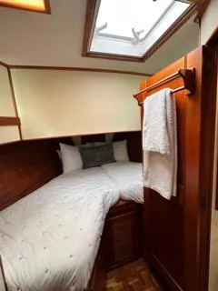 Its About Time Yacht Photos Pics Cozy cabin interior of 1996 Grand Banks Classic yacht with skylight and wooden finishes.