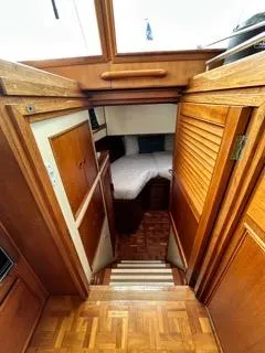 Its About Time Yacht Photos Pics Interior view of 1996 Grand Banks Classic yacht with wooden finishes and cozy cabin.
