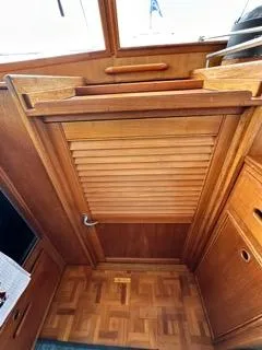 Its About Time Yacht Photos Pics 1996 Grand Banks Classic interior with wooden louvered door and parquet flooring.