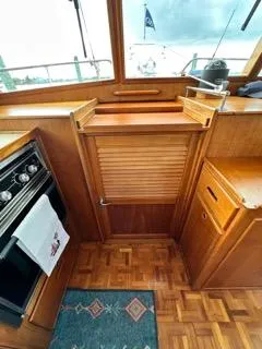 Its About Time Yacht Photos Pics Interior of 1996 Grand Banks Classic yacht with wooden cabinetry and nautical decor.