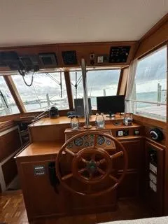 Its About Time Yacht Photos Pics 1996 Grand Banks Classic boat helm with wooden steering wheel and navigation instruments.