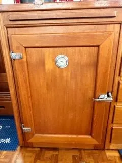 Its About Time Yacht Photos Pics Wooden cabinet door with metal latch on a 1996 Grand Banks Classic boat.