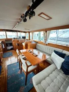 Its About Time Yacht Photos Pics Interior of a 1996 Grand Banks Classic yacht with elegant wood furnishings and plush seating.