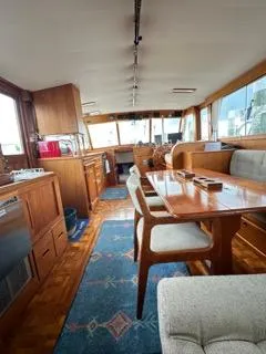 Its About Time Yacht Photos Pics Interior of a 1996 Grand Banks Classic yacht with wooden furnishings and a dining area.