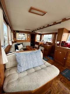 Its About Time Yacht Photos Pics Interior of a 1996 Grand Banks Classic yacht with cozy seating and wooden furnishings.