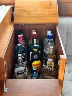 Its About Time Yacht Photos Pics Liquor cabinet on 1996 Grand Banks Classic boat, featuring various bottles.