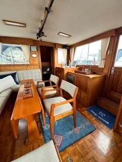 Its About Time Yacht Photos Pics Interior of 1996 Grand Banks Classic yacht with wooden furnishings and seating area.