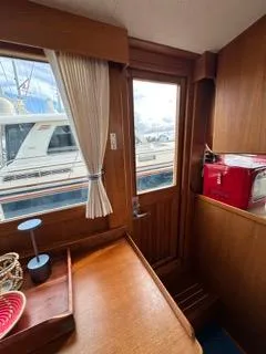 Its About Time Yacht Photos Pics Interior of a 1996 Grand Banks Classic yacht with wooden finish and window view.