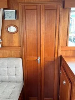 Its About Time Yacht Photos Pics 1996 Grand Banks Classic interior with wooden cabinetry and cushioned seating.