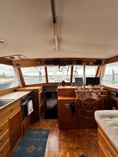Its About Time Yacht Photos Pics Interior of a 1996 Grand Banks Classic yacht with wooden helm and panoramic windows.