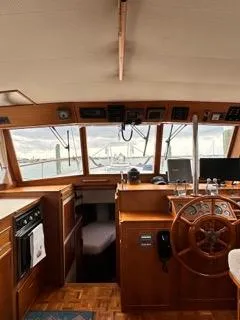 Its About Time Yacht Photos Pics Interior of a 1996 Grand Banks Classic yacht, featuring a wooden helm and navigation equipment.