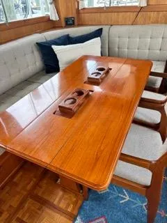 Its About Time Yacht Photos Pics Interior of 1996 Grand Banks Classic yacht with wooden table and cushioned seating.