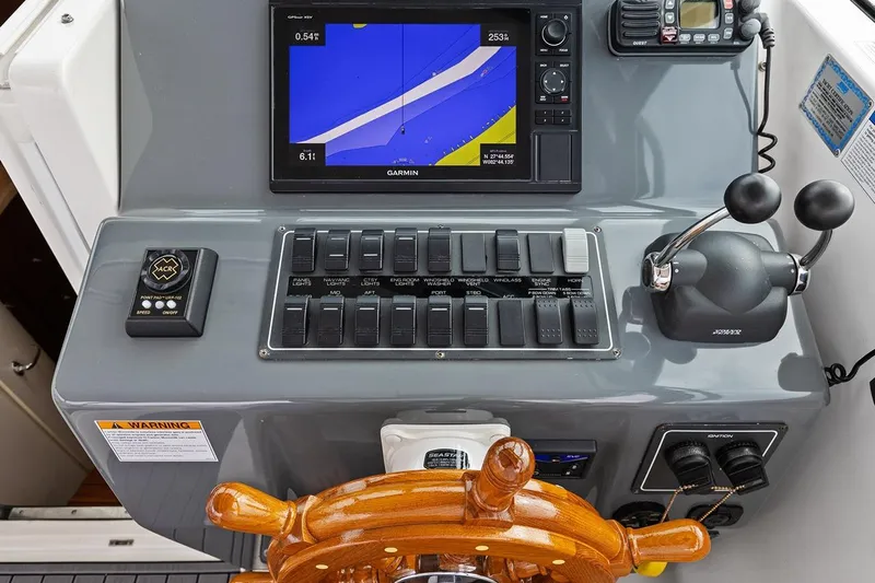  Yacht Photos Pics 2005 Tiara Open Classic boat dashboard with navigation controls and wooden steering wheel.