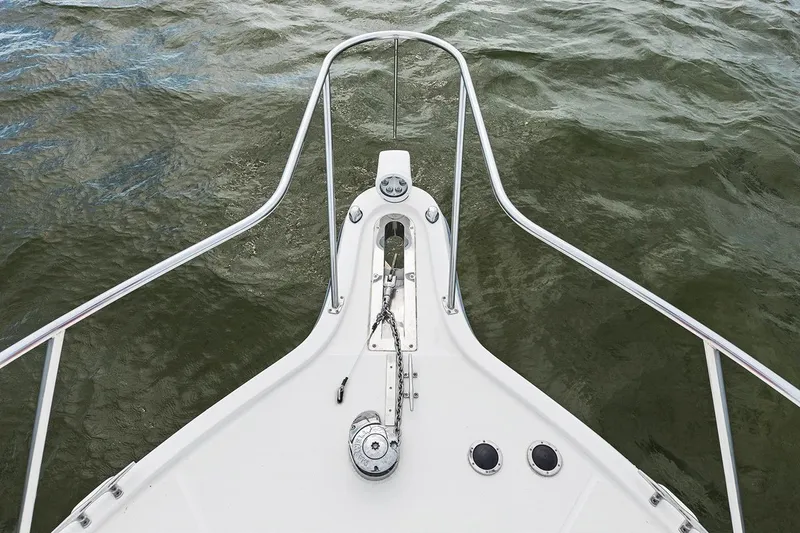  Yacht Photos Pics Bow of 2005 Tiara Open Classic boat with anchor and railing on water.