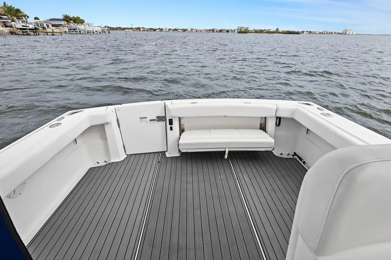  Yacht Photos Pics 2005 Tiara Open Classic boat deck with seating, overlooking calm waters and distant shoreline.