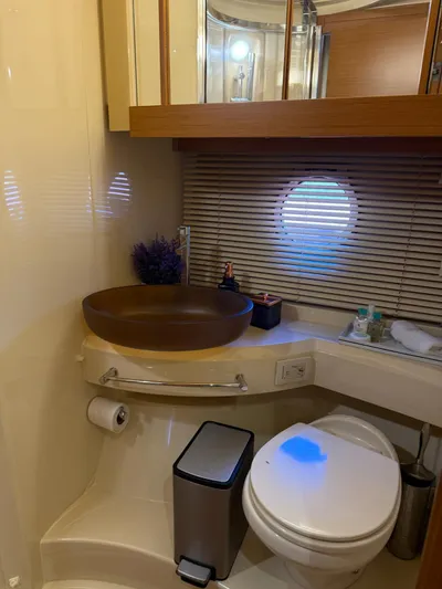 Luna Yacht Photos Pics Luxurious bathroom in 2014 Azimut Atlantis 45 yacht with modern fixtures and porthole window.