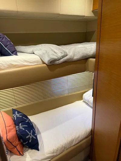 Luna Yacht Photos Pics Bunk beds in 2014 Azimut Atlantis 45 yacht cabin, featuring cozy bedding and pillows.