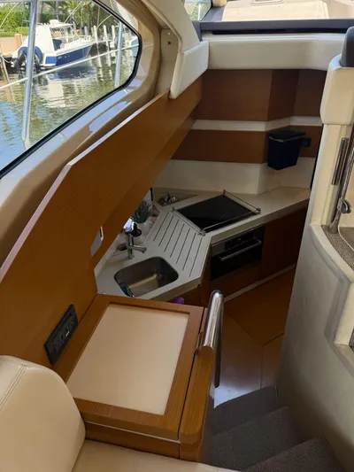 Luna Yacht Photos Pics Interior of 2014 Azimut Atlantis 45 yacht, featuring a compact kitchen with modern amenities.