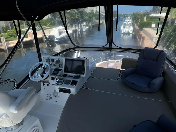 Luna Yacht Photos Pics Interior view of 2014 Azimut Atlantis 45 yacht cockpit with steering and seating.