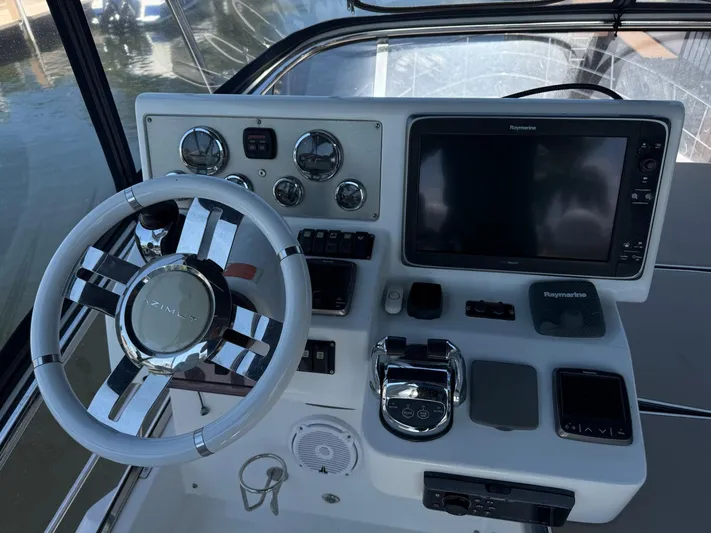 Luna Yacht Photos Pics Steering console of 2014 Azimut Atlantis 45 yacht with navigation equipment.