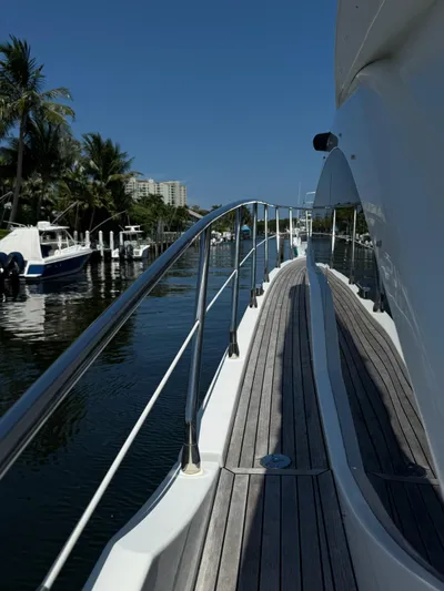 Luna Yacht Photos Pics Side view of 2014 Azimut Atlantis 45 yacht docked by palm trees and water.