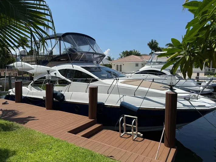 Luna Yacht Photos Pics Azimut Atlantis 45 yacht docked, 2014 model, surrounded by tropical greenery.