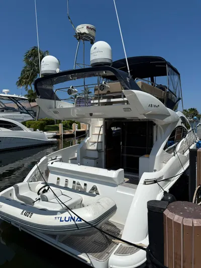 Luna Yacht Photos Pics 2014 Azimut Atlantis 45 yacht docked, featuring a small inflatable boat named "Luna."