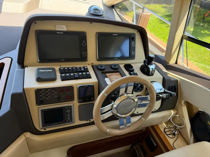 Luna Yacht Photos Pics Cockpit of 2014 Azimut Atlantis 45 yacht with advanced navigation controls and steering wheel.