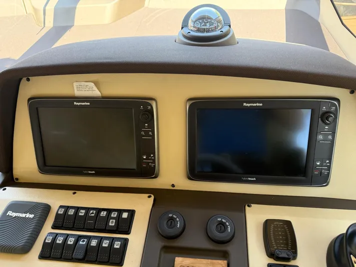 Luna Yacht Photos Pics Control panel of 2014 Azimut Atlantis 45 yacht with Raymarine displays and compass.