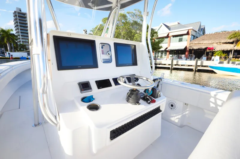  Yacht Photos Pics 2014 Contender 39 ST boat helm with dual screens and steering wheel, dockside view.