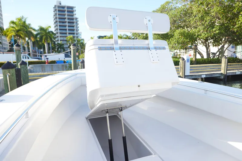  Yacht Photos Pics 2014 Contender 39 ST boat with open storage compartment, docked near palm trees.