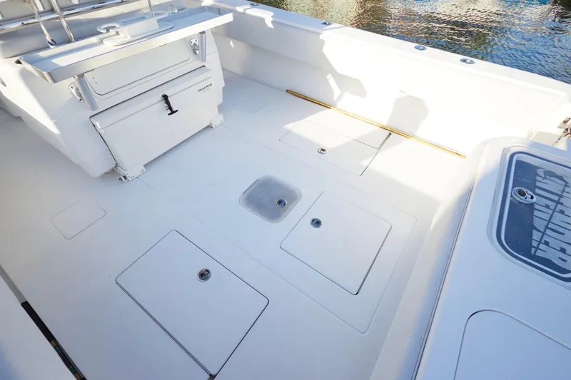  Yacht Photos Pics 2014 Contender 39 ST boat deck with storage compartments and seating area.
