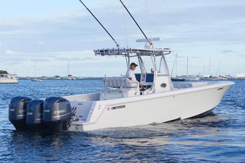  Yacht Photos Pics 2014 Contender 39 ST boat with triple Yamaha engines cruising on open water.