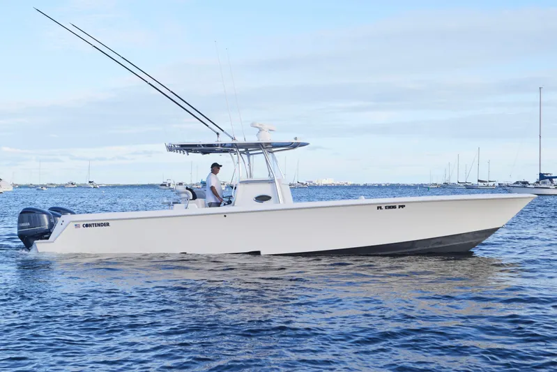  Yacht Photos Pics 2014 Contender 39 ST boat on water with fishing rods and Yamaha engines.