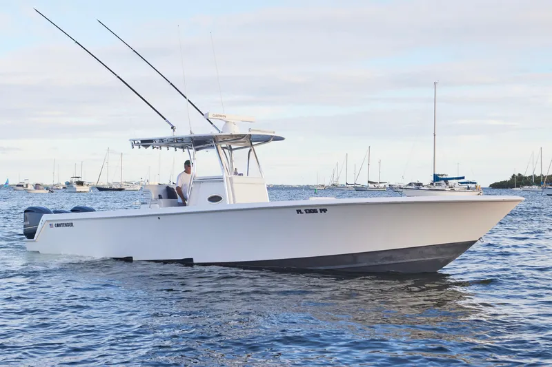  Yacht Photos Pics 2014 Contender 39 ST boat cruising on water with fishing rods, surrounded by other boats.