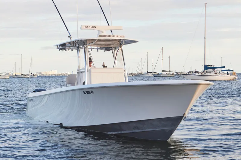  Yacht Photos Pics 2014 Contender 39 ST boat cruising on calm waters with sailboats in the background.
