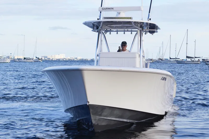  Yacht Photos Pics 2014 Contender 39 ST boat cruising on a calm sea with distant sailboats.