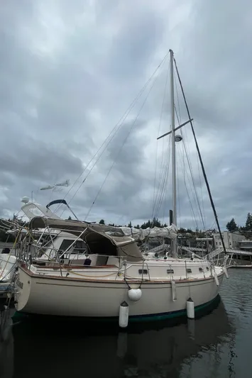  Yacht Photos Pics 1995 Island Packet 40 sailboat docked under cloudy skies.