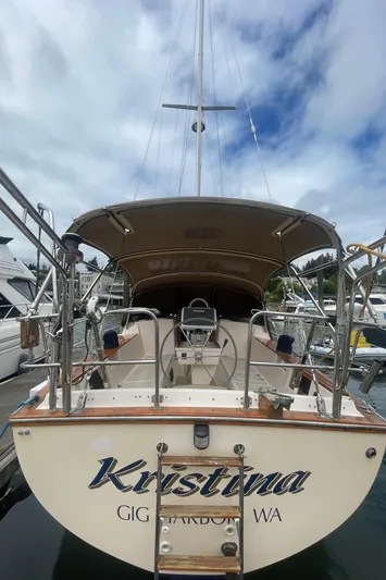  Yacht Photos Pics Island Packet 40 sailboat, 1995 model, docked with a covered cockpit and clear sky above.