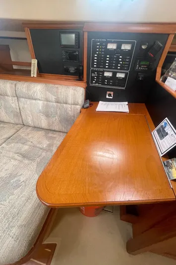  Yacht Photos Pics Navigation station of a 1995 Island Packet 40 sailboat with control panels and seating.