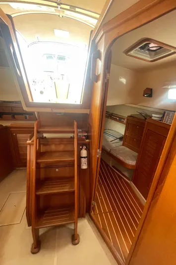  Yacht Photos Pics Interior of 1995 Island Packet 40 sailboat, featuring wooden stairs and cozy cabin space.