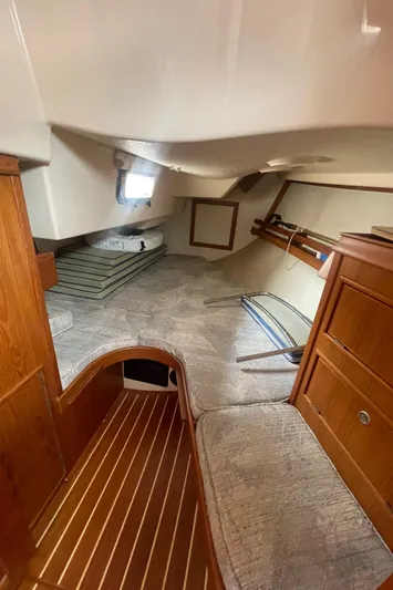  Yacht Photos Pics 1995 Island Packet 40 interior cabin with wooden finishes and cozy sleeping area.