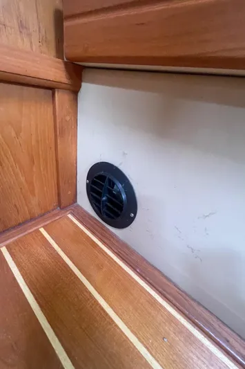  Yacht Photos Pics Wooden interior of a 1995 Island Packet 40 sailboat with a circular vent.