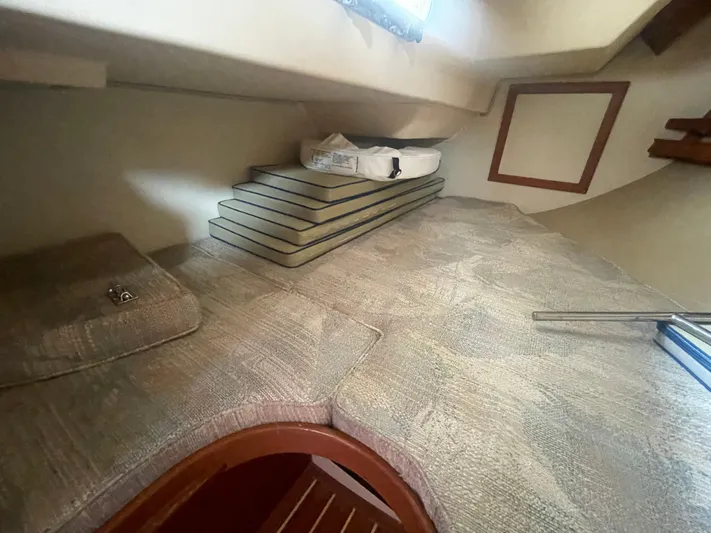  Yacht Photos Pics Interior cabin of 1995 Island Packet 40 sailboat with cushioned seating and storage.